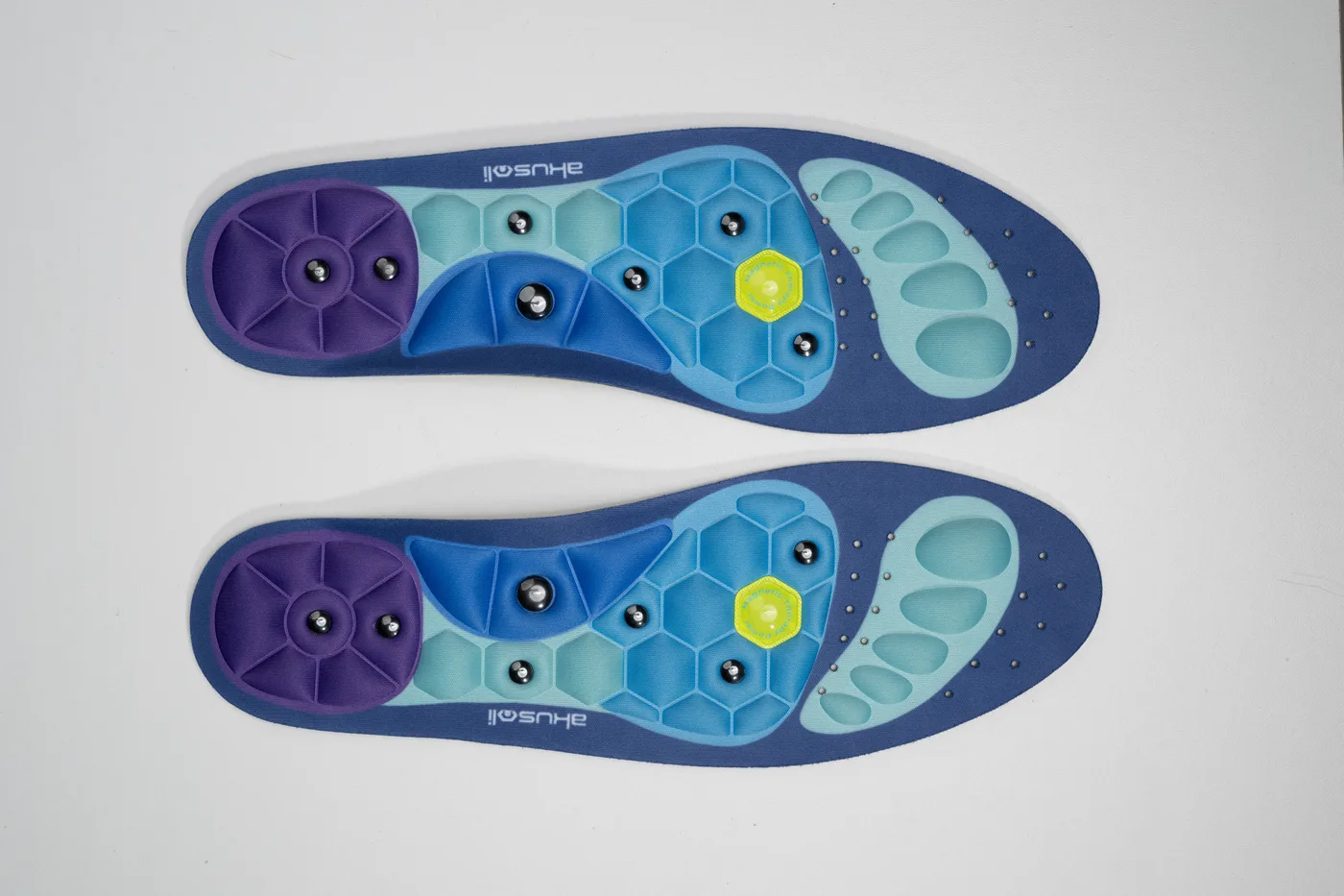 Clean pair of Akusoli insoles on a light background