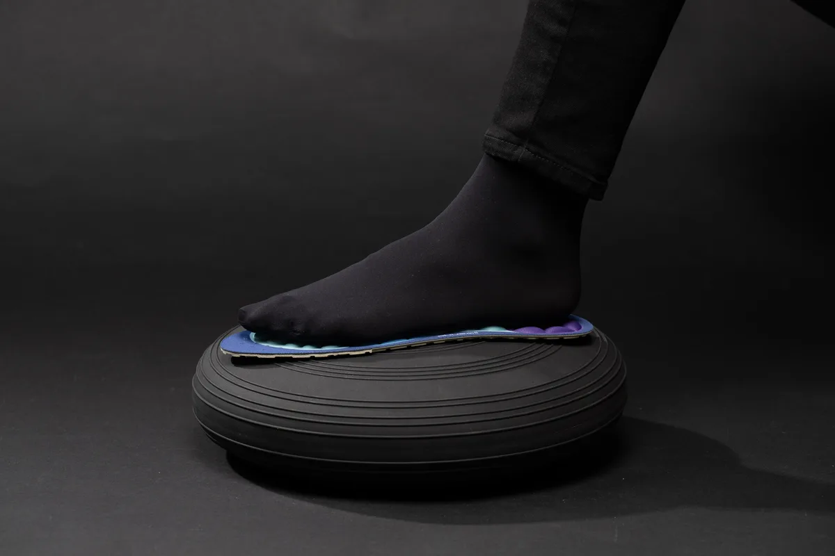 Foot pressing down on an Akusoli insole